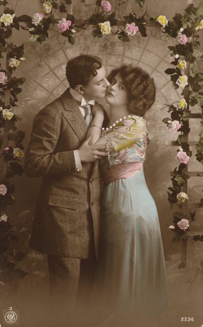 Couple standing under an arch of roses by English Photographer